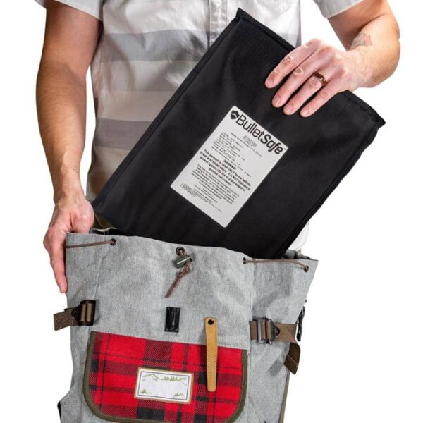 Man putting backpack panel inside a bag