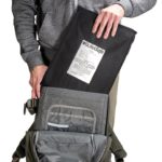 Man inserting backpack panel in a bag