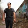 A man standing straight while wearing a bulletproof vest