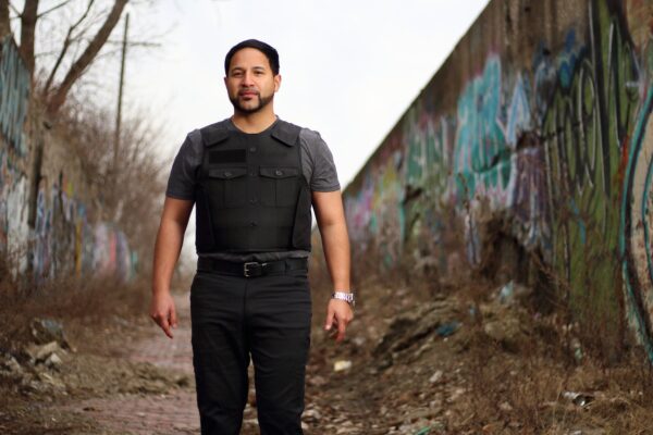 A man standing straight while wearing a bulletproof vest