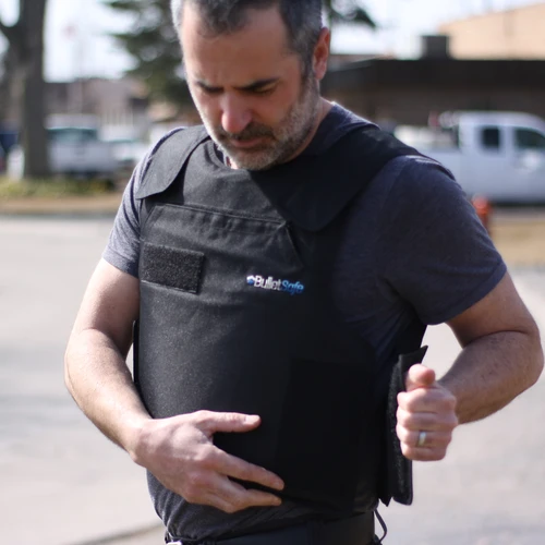 man putting on a bulletproof vest