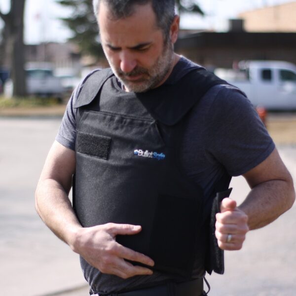 A man putting on a 4XL Bulletsafe bulletproof vest