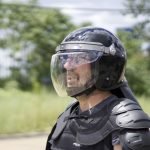 A man wearing a riot helmet