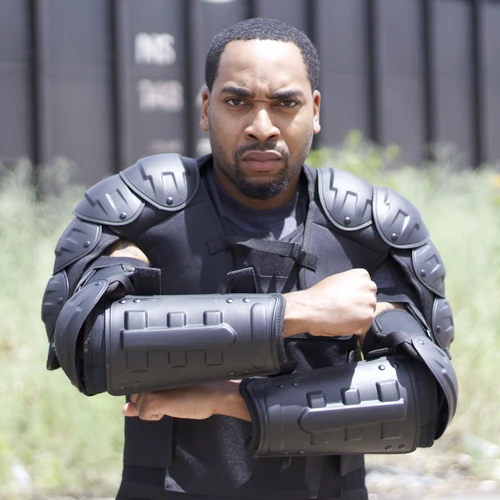 man wearing bulletproof riot shoulder and arm pads