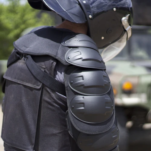 man wearing bulletproof vest, arm and shoulder pads