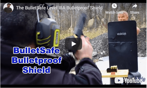a man shooting a bulletproof shield