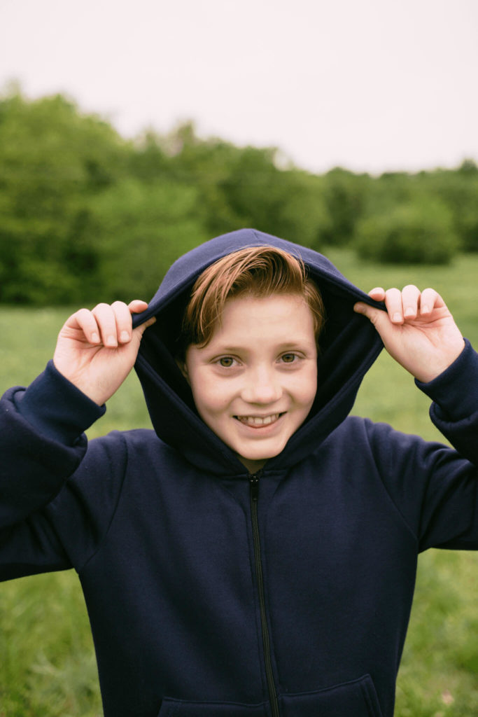 smiling young boy wearing bulletproof kids hoodie