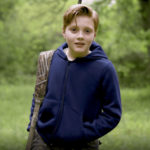 young boy wearing bulletproof kids hoodie and a backpack