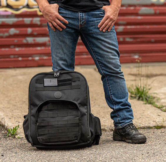 man standing beside a Tactical Bulletproof Backpack