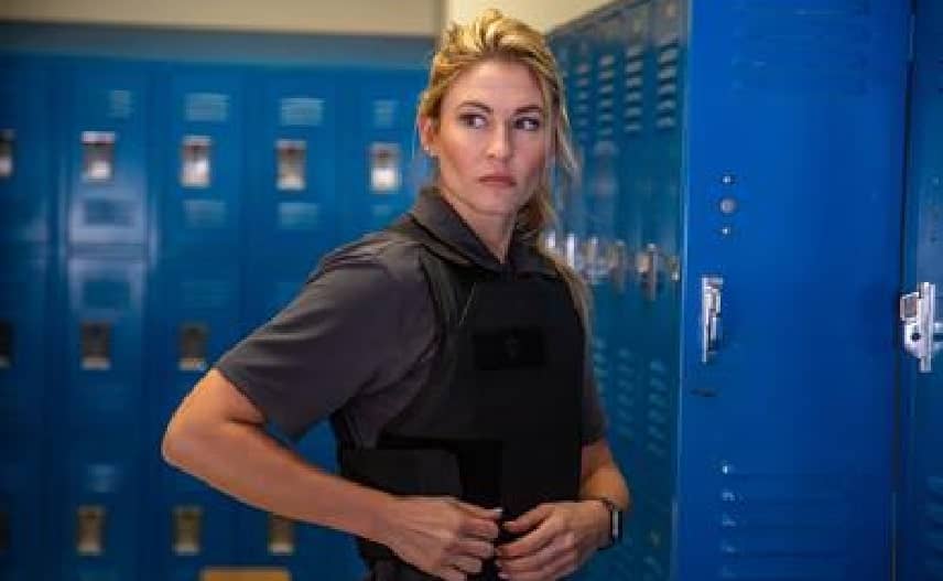 woman wearing bulletproof vest standing near the lockers