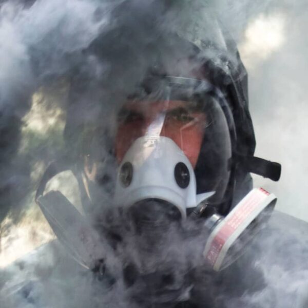 man wearing Breathesafe Respirator surrounded with smoke