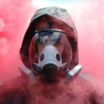 man wearing Breathesafe Respirator surrounded with pink smoke