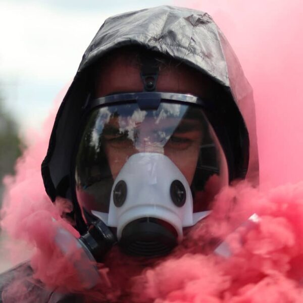 man wearing Breathesafe Respirator surrounded with pink smoke