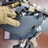 Man holding black NIJ Level IIIA+ Full Face Bulletproof Mask side view