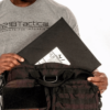 Man pulling out a Level IIIA Armor Panel Insert 11" x 14" inside an Ultimate Patrol Bag