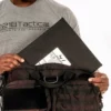 Man pulling out a Level IIIA Armor Panel Insert 11" x 14" inside an Ultimate Patrol Bag
