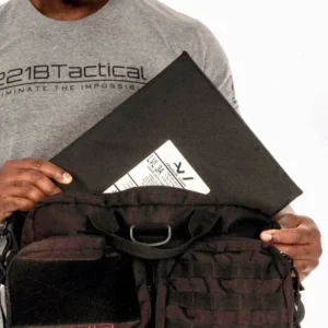 Man pulling out a Level IIIA Armor Panel Insert 11" x 14" inside an Ultimate Patrol Bag