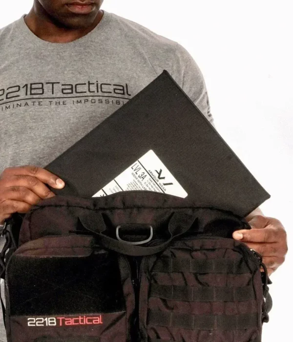 Man pulling out a Level IIIA Armor Panel Insert 11" x 14" inside an Ultimate Patrol Bag