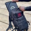 Man pulling out a Black Level IIIA Armor Panel inside an Armored Backpack Tactical Assault Bag