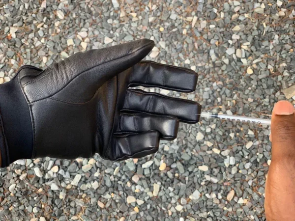 Demo injection of man wearing black Needle Resistant and Touch Screen Capable Hero Gloves 2.0 SL